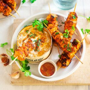 Indian chicken skewers dipped in Mont-d’Or