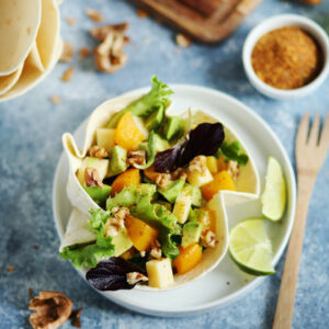 Avocado, peach and walnut salad in a tortilla bowl